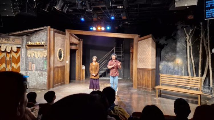 view of illuminated stage with a woman and man standing in a door frame