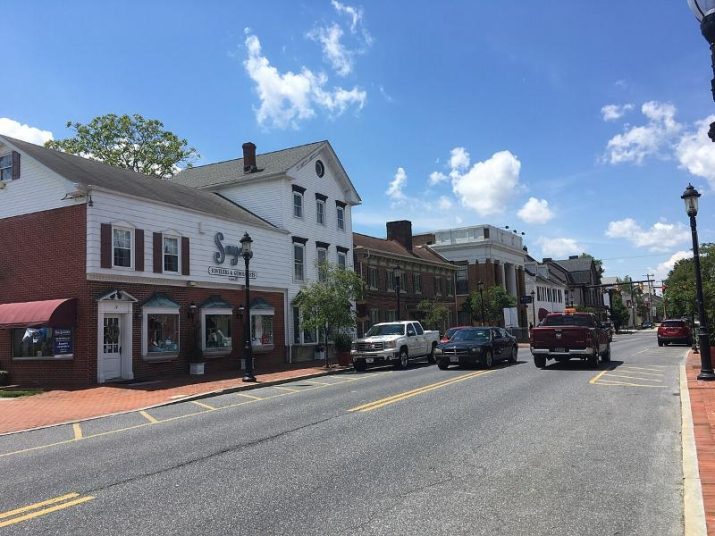 empty street lined by white, American houses