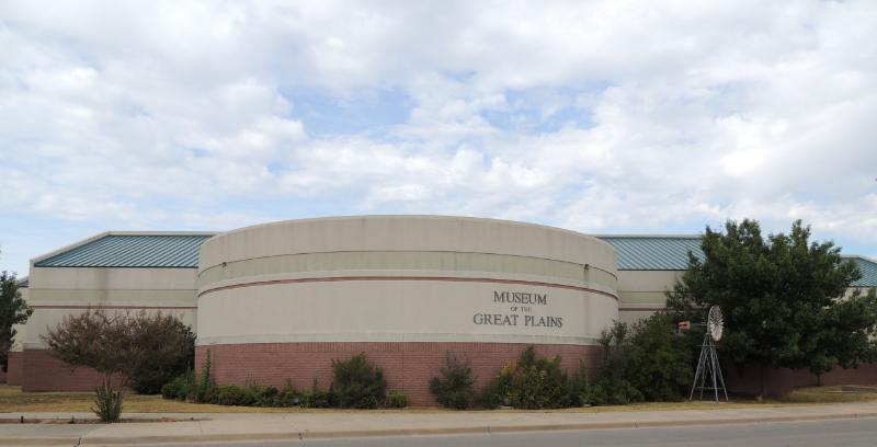 outside view of round museum in grey and red colours
